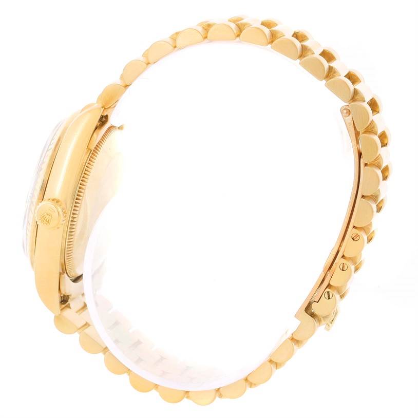 The image shows a side view of a Rolex President 68278 Women's Yellow Gold Champagne Dial 68278 Women's Yellow Gold Champagne Dial model watch, focusing on the gold band and crown.