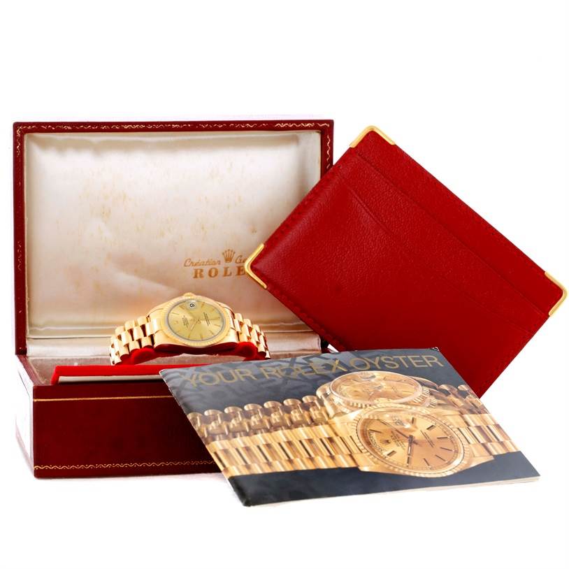 This image shows a Rolex President 68278 Women's Yellow Gold Champagne Dial 68278 Women's Yellow Gold Champagne Dial watch in its open box along with an accessory and booklet.