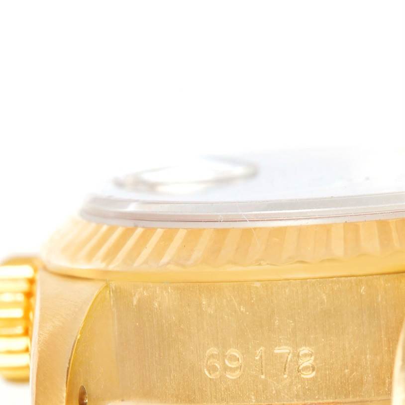 This close-up image shows the side case, fluted bezel, crown, and part of the crystal of the Rolex President 69178 Women's Yellow Gold Black Dial 69178 Women's Yellow Gold Black Dial model, with its reference number visible.