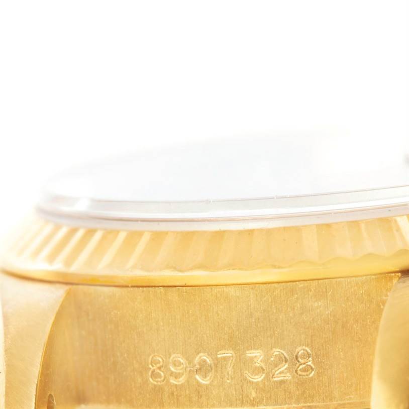 This image shows a close-up of the serial number and part of the bezel of a Rolex President 69178 Women's Yellow Gold Black Dial 69178 Women's Yellow Gold Black Dial model watch.