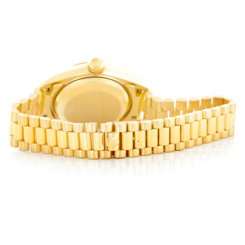 The image shows the back view of a Rolex President 69178 Women's Yellow Gold Black Dial 69178 Women's Yellow Gold Black Dial model watch, featuring its gold case and bracelet.