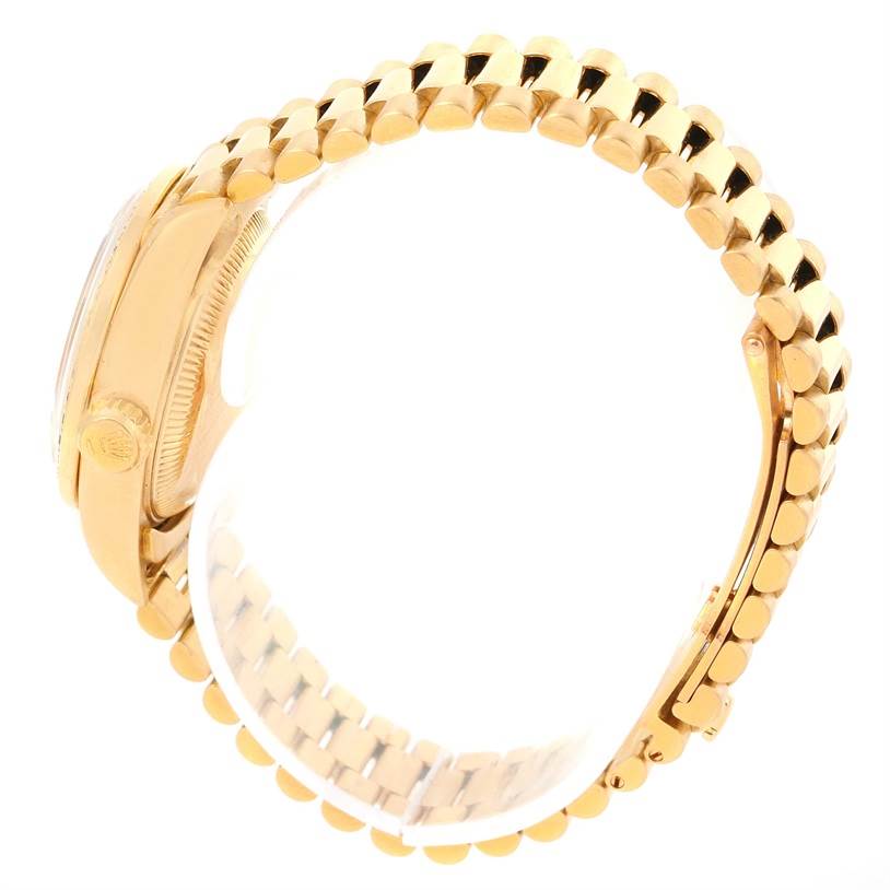 The image shows a side view of a Rolex President 69168 Women's Yellow Gold Champagne Dial 69168 Women's Yellow Gold Champagne Dial model watch, highlighting its gold case and distinctive gold bracelet band.