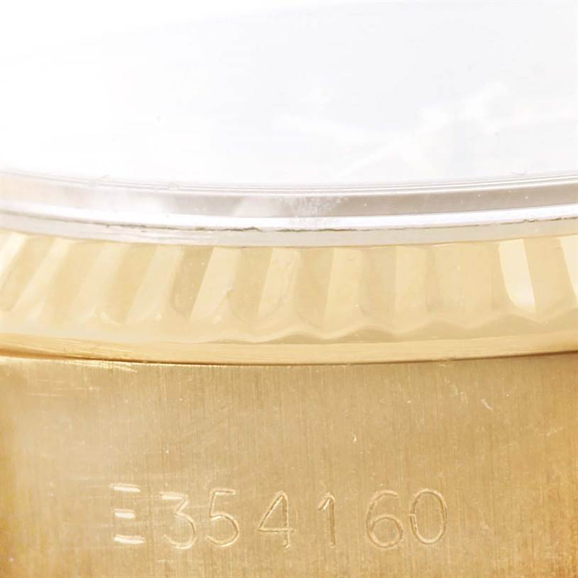 The image shows a close-up angle of the serial number and the fluted bezel of a Rolex President 69178 Women
s Yellow Gold Champagne Dial 69178 Women
s Yellow Gold Champagne Dial model watch.
