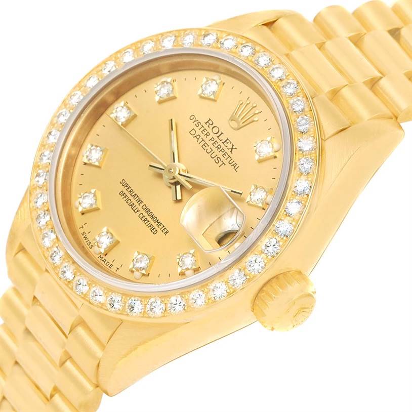 The image shows a Rolex President 69178 Women's Yellow Gold Champagne Dial 69178 Women's Yellow Gold Champagne Dial model from a tilted angle, highlighting its gold case, diamond bezel, and bracelet.