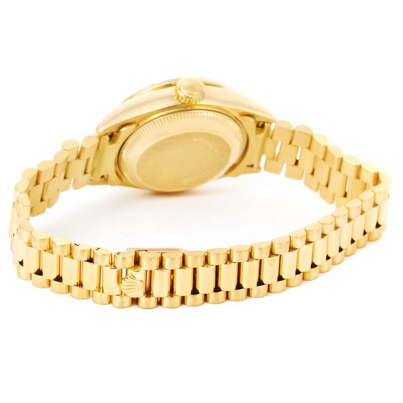 This image shows the back case and bracelet of a Rolex President 69178 Women's Yellow Gold Champagne Dial 69178 Women's Yellow Gold Champagne Dial model watch at an upward angle.