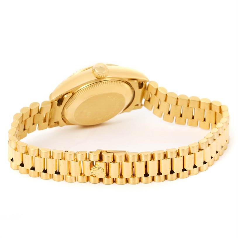 The image shows the side and back of a Rolex President 69178 Women's Yellow Gold Blue Dial 69178 Women's Yellow Gold Blue Dial model watch, highlighting its gold bracelet and case back.