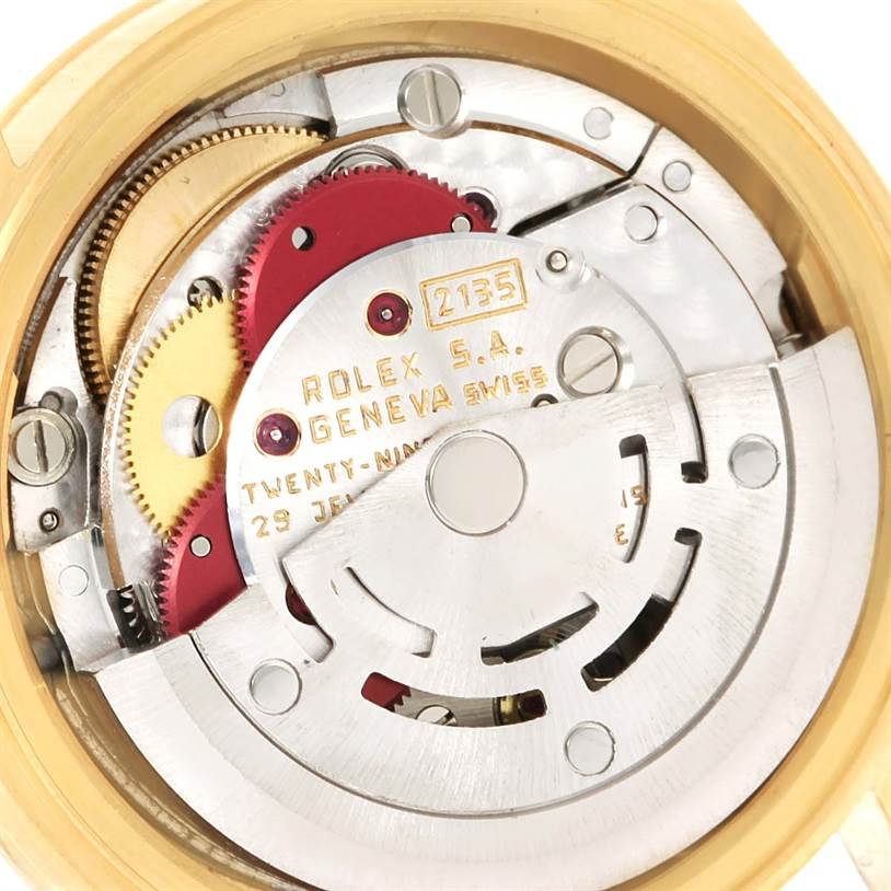 The image shows the internal movement parts of a Rolex President 69178 Women's Yellow Gold Blue Dial 69178 Women's Yellow Gold Blue Dial model, including gears and mechanical components.