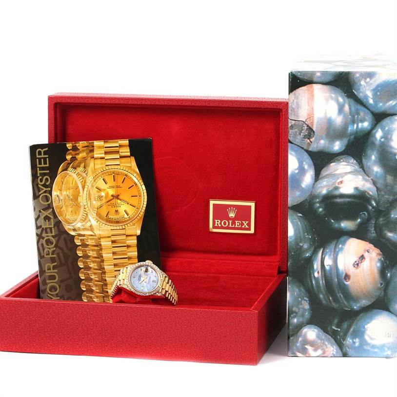 The image shows a Rolex President 69158 Women's Yellow Gold Mother of Pearl Dial 69158 Women's Yellow Gold Mother of Pearl Dial model watch, box, and booklet from a front angle.