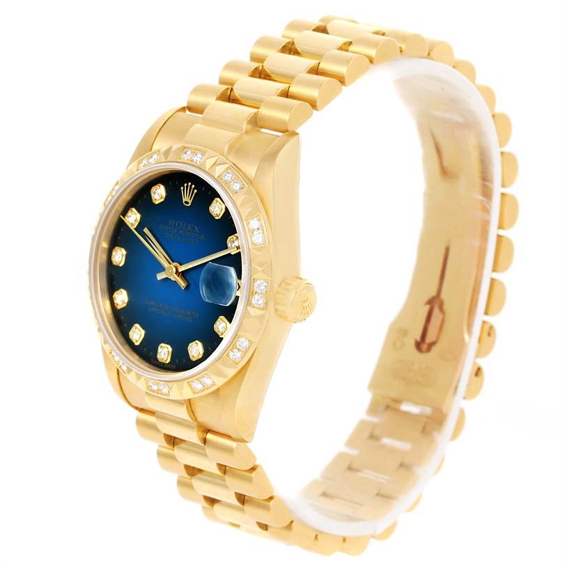 The image shows a side angle view of a Rolex President 68258 Women's Yellow Gold Blue Dial 68258 Women's Yellow Gold Blue Dial model watch, highlighting the dial, bezel, crown, and a portion of the gold bracelet.