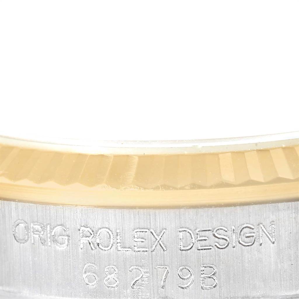 This image shows a close-up of the side engraving on a Rolex President 68279B Women's White Gold Brown Dial 68279B Women's White Gold Brown Dial model watch, highlighting "ORIG ROLEX DESIGN 68279B."