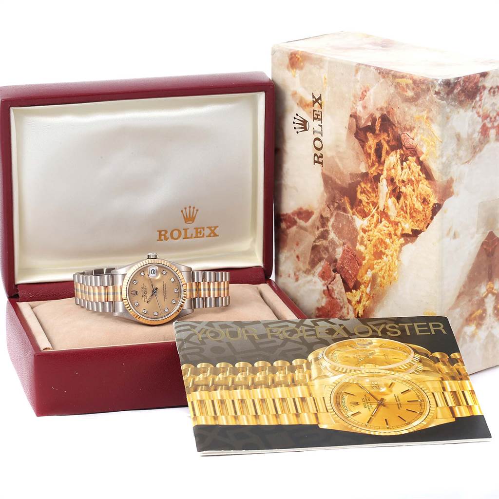 This image shows a Rolex President 68279B Women's White Gold Brown Dial 68279B Women's White Gold Brown Dial model watch displayed in an open box, with its packaging and booklet beside it.