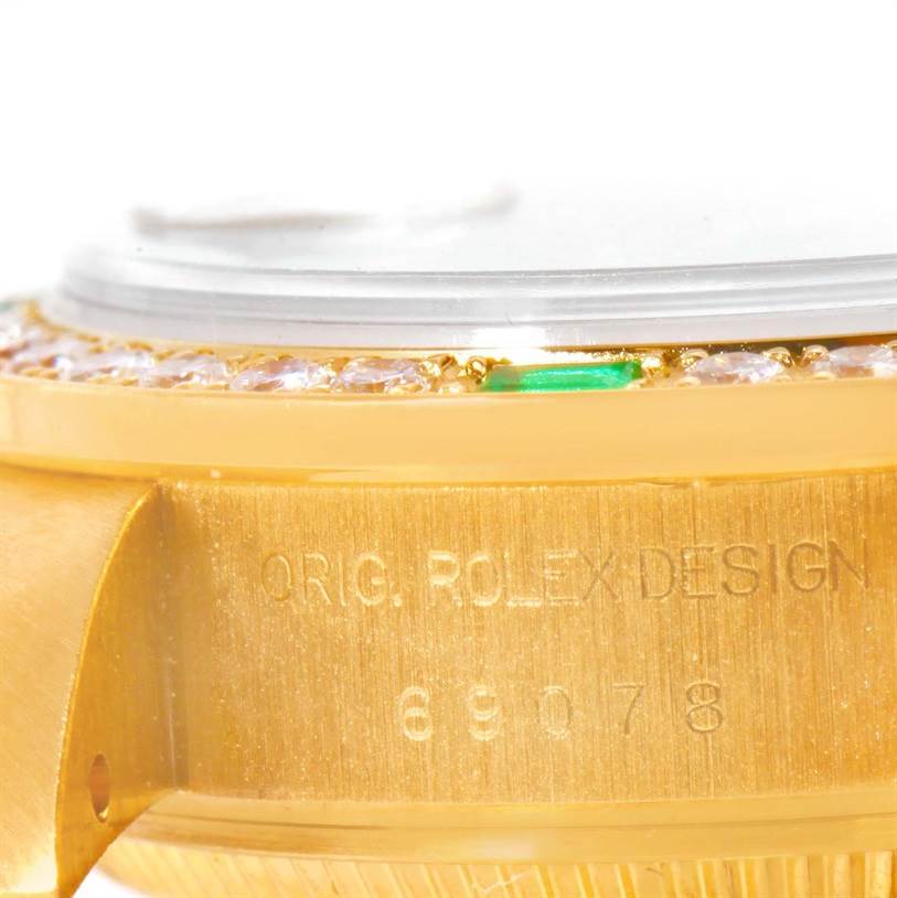 The image shows a close-up angle of the side of a Rolex President 69078 Women's Yellow Gold Champagne Dial 69078 Women's Yellow Gold Champagne Dial watch case, featuring its bezel and engraved model details.