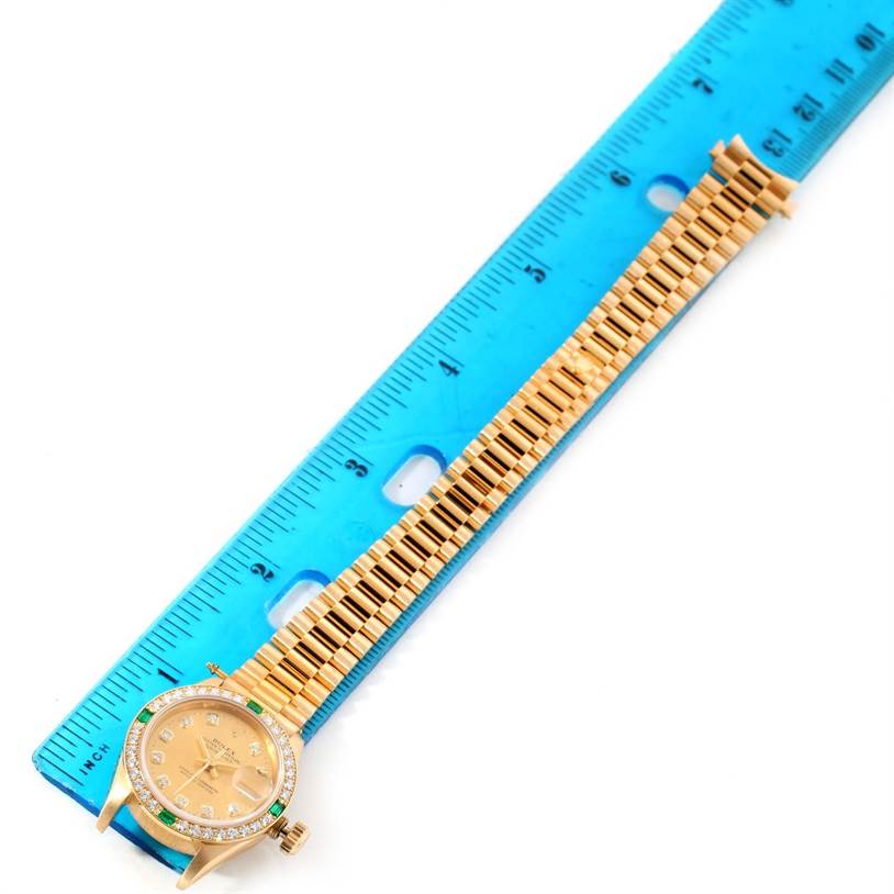 The image shows a Rolex President 69078 Women's Yellow Gold Champagne Dial 69078 Women's Yellow Gold Champagne Dial model watch laid flat beside a ruler, displaying the watch face, crown, and bracelet.