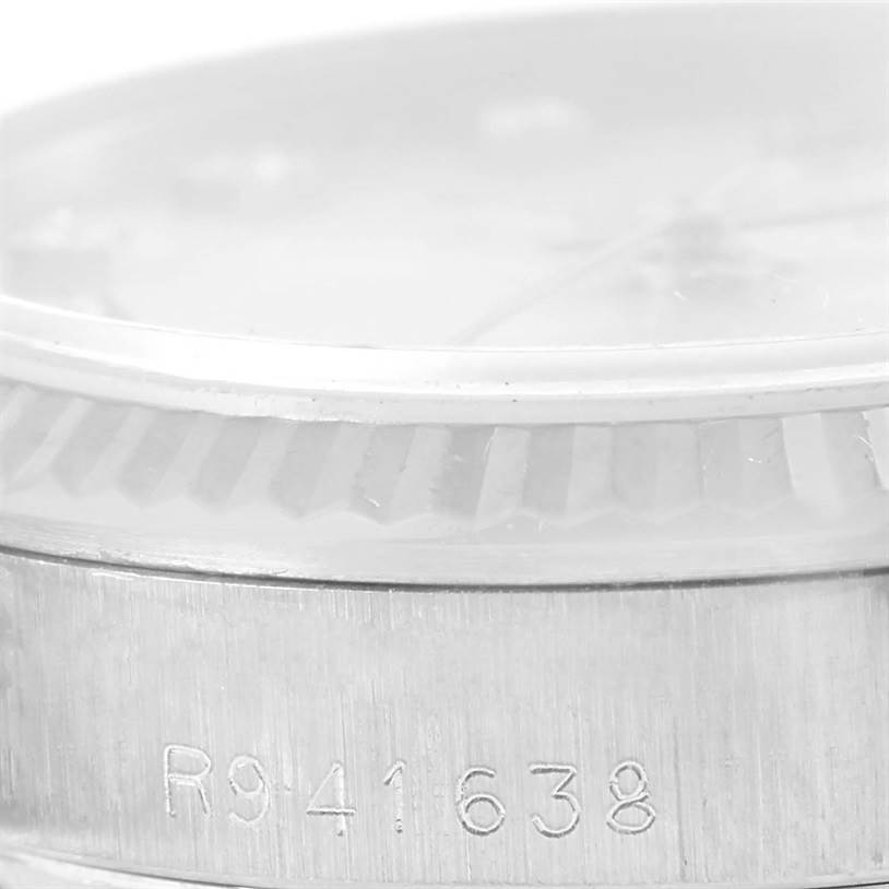 This image shows a close-up of the case side and part of the bezel with engravings on a Rolex President 68279 Women's White Gold Silver Dial 68279 Women's White Gold Silver Dial model watch.