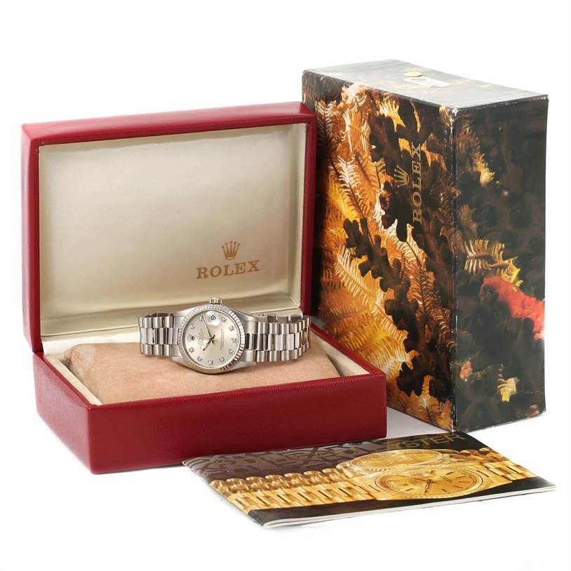The image shows the Rolex President 68279 Women's White Gold Silver Dial 68279 Women's White Gold Silver Dial model watch in its open box, alongside the box cover and a booklet.