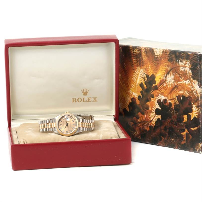 The Rolex President 69179 Women's White Gold Brown Dial 69179 Women's White Gold Brown Dial model watch is shown from the front, with its box and outer packaging also visible.