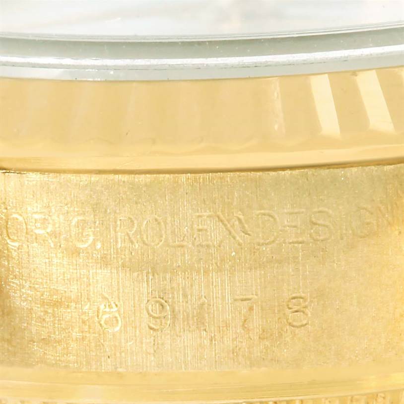 This image shows an extreme close-up of the side of a Rolex President 69178 Women's Yellow Gold White Dial 69178 Women's Yellow Gold White Dial watch, focusing on its model number engraving.