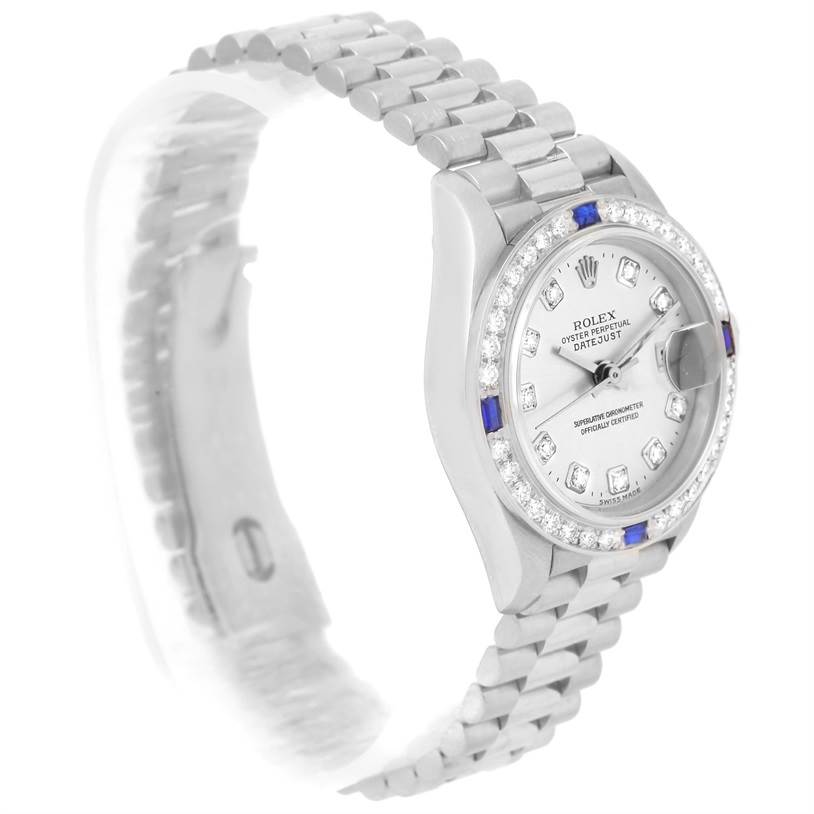 The image shows the Rolex President 79179 Women's White Gold Silver Dial 79179 Women's White Gold Silver Dial model watch from a side angle highlighting the bracelet, dial, and gemstone bezel.