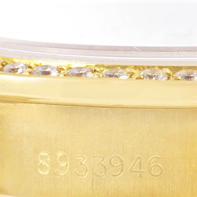 This close-up image shows the serial number and part of the diamond bezel on a Rolex President 69168 Women's Yellow Gold Champagne Dial 69168 Women's Yellow Gold Champagne Dial watch.