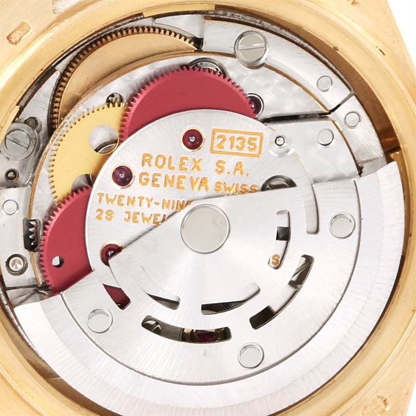 This close-up shows the intricate movement mechanism of the Rolex President 69168 Women's Yellow Gold Champagne Dial 69168 Women's Yellow Gold Champagne Dial model watch, highlighting gears and components.