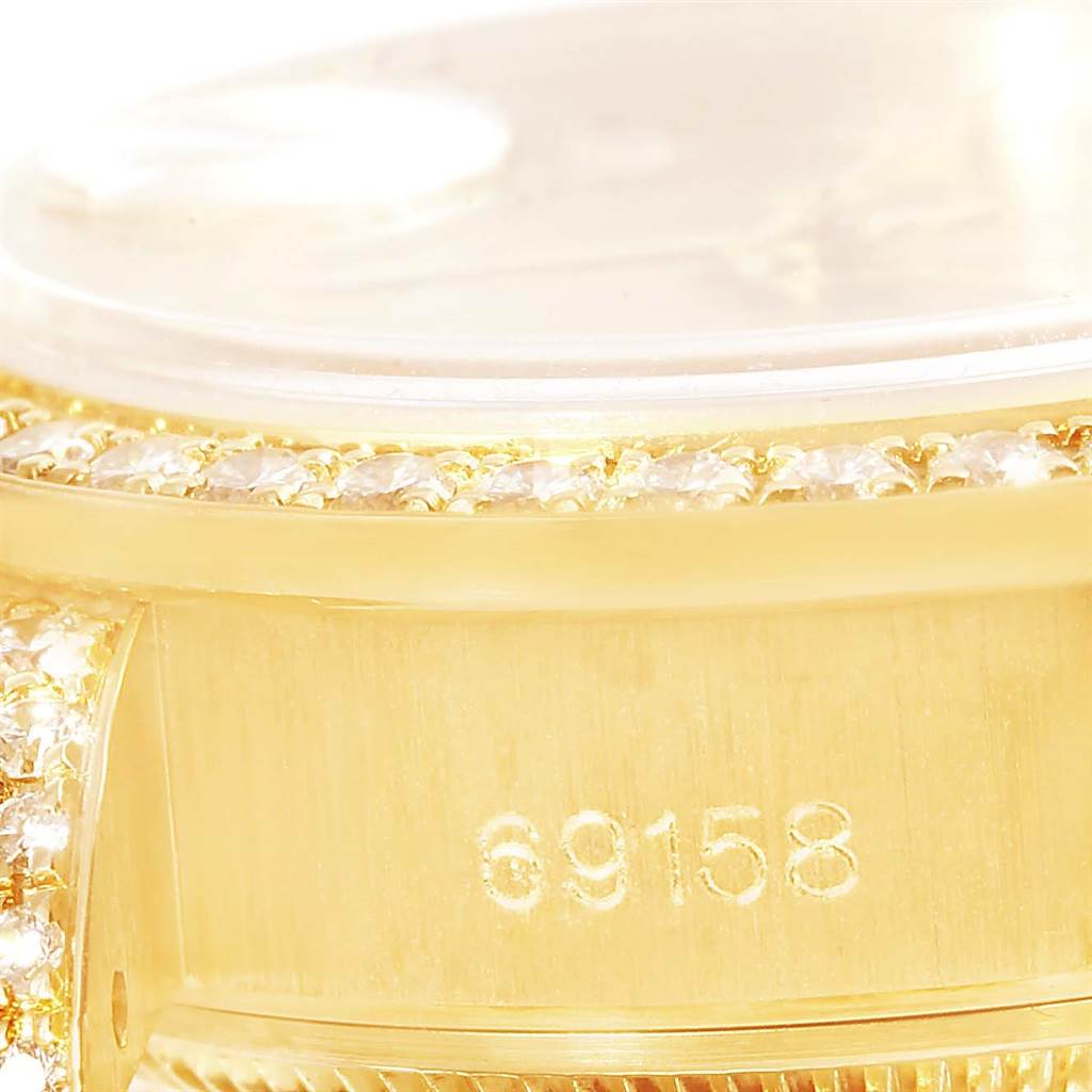 This image shows a close-up of the side of a Rolex President 69158 Men
s Yellow Gold Champagne Dial 69158 Men
s Yellow Gold Champagne Dial model watch, highlighting its serial number 69158 and diamond bezel.