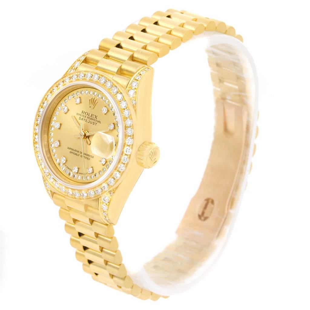 The image shows a Rolex President 69158 Men
s Yellow Gold Champagne Dial 69158 Men
s Yellow Gold Champagne Dial model watch at a three-quarter angle, highlighting its gold band and diamond-encrusted bezel.