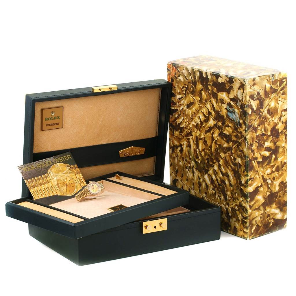 The image shows a Rolex President 69158 Men
s Yellow Gold Champagne Dial 69158 Men
s Yellow Gold Champagne Dial model watch with its box and packaging, viewed from an angle showing the open case.