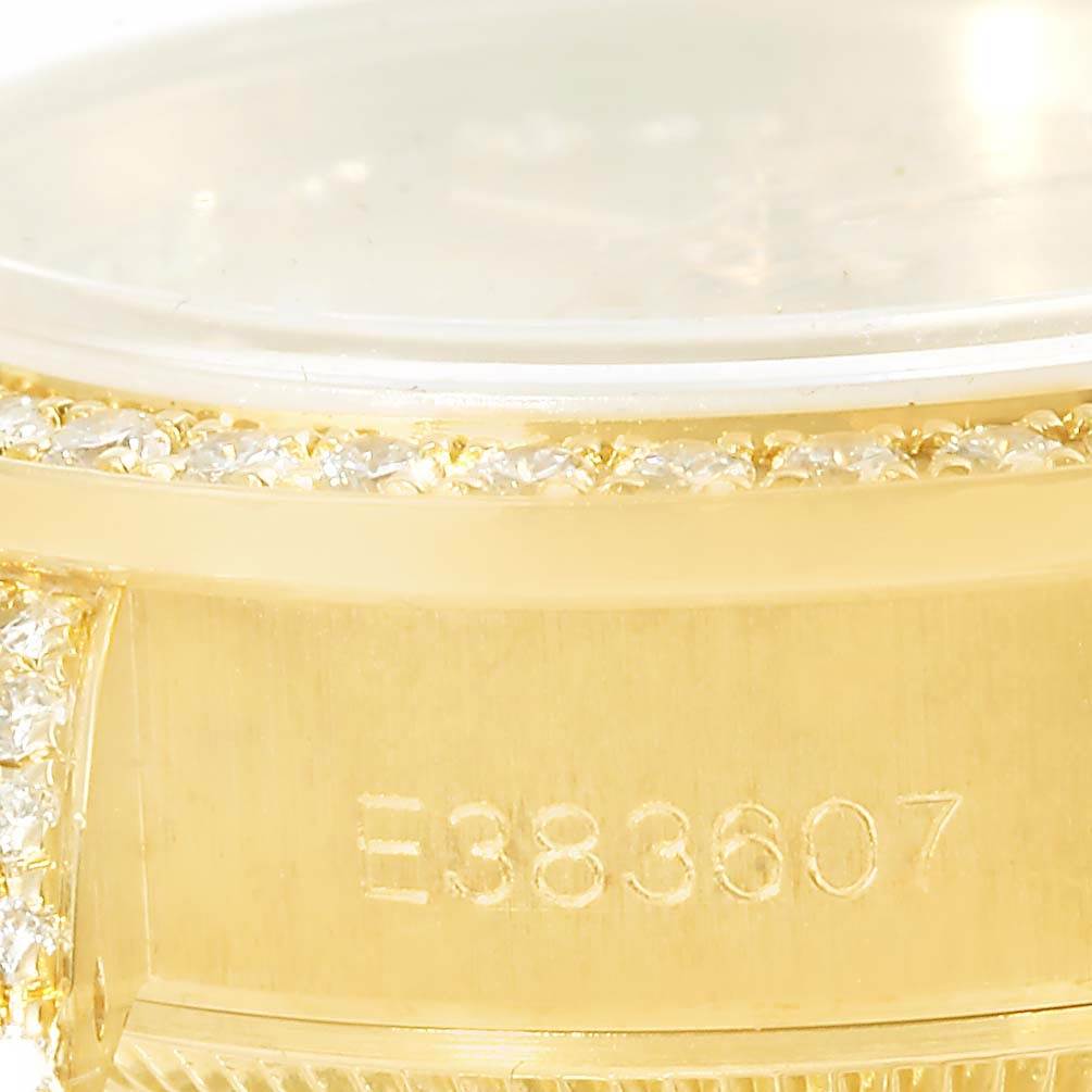 The image shows a close-up of the side of a Rolex President 69158 Men
s Yellow Gold Champagne Dial 69158 Men
s Yellow Gold Champagne Dial model watch, highlighting the serial number and part of the diamond bezel.