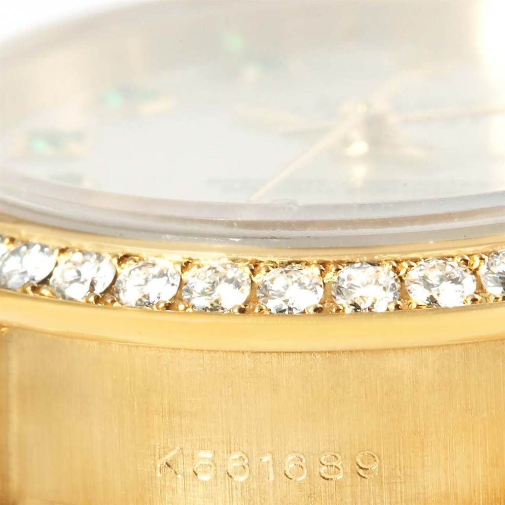 This close-up shows the diamond bezel and part of the case with serial number of a Rolex President 179138 Women's Yellow Gold Mother of Pearl Dial 179138 Women's Yellow Gold Mother of Pearl Dial model.