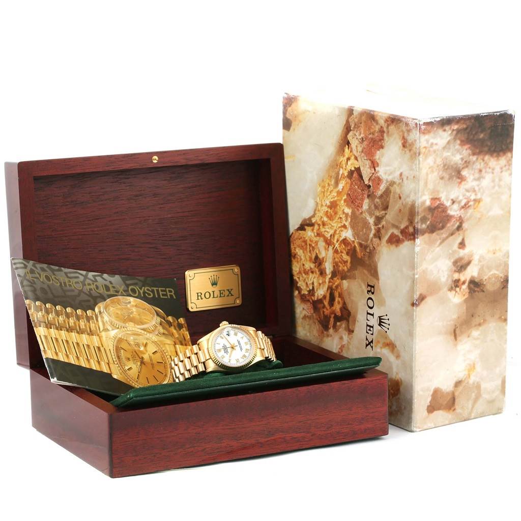 The Rolex President 68278 Women's Yellow Gold White Dial 68278 Women's Yellow Gold White Dial model watch is shown at a front angle in an open wooden box, alongside its packaging.