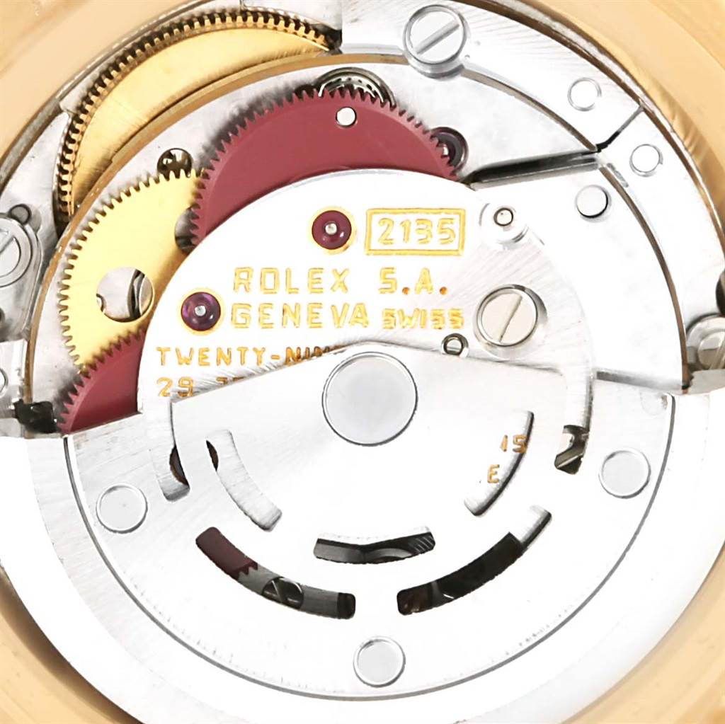 The image shows the movement of a Rolex President 69138 Women's Yellow Gold Blue Dial 69138 Women's Yellow Gold Blue Dial model watch, highlighting the inner mechanics and gears.