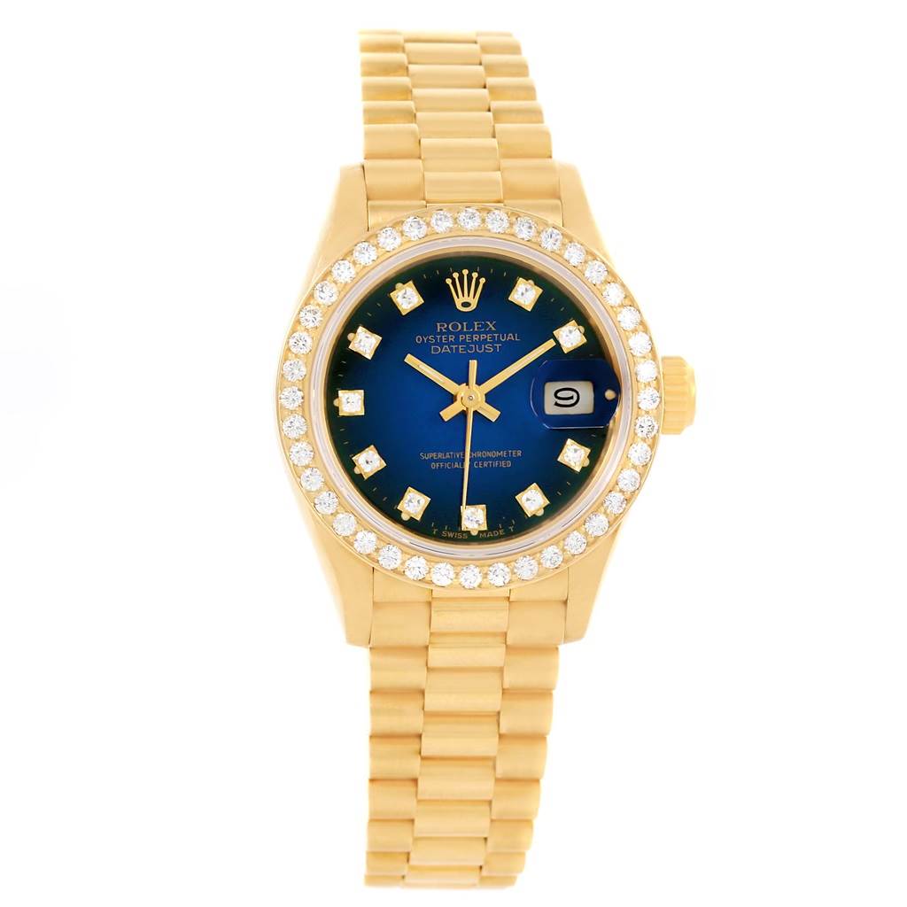 The image shows a Rolex President 69138 Women's Yellow Gold Blue Dial 69138 Women's Yellow Gold Blue Dial model watch from the front, highlighting its blue dial, diamond bezel, and gold bracelet.