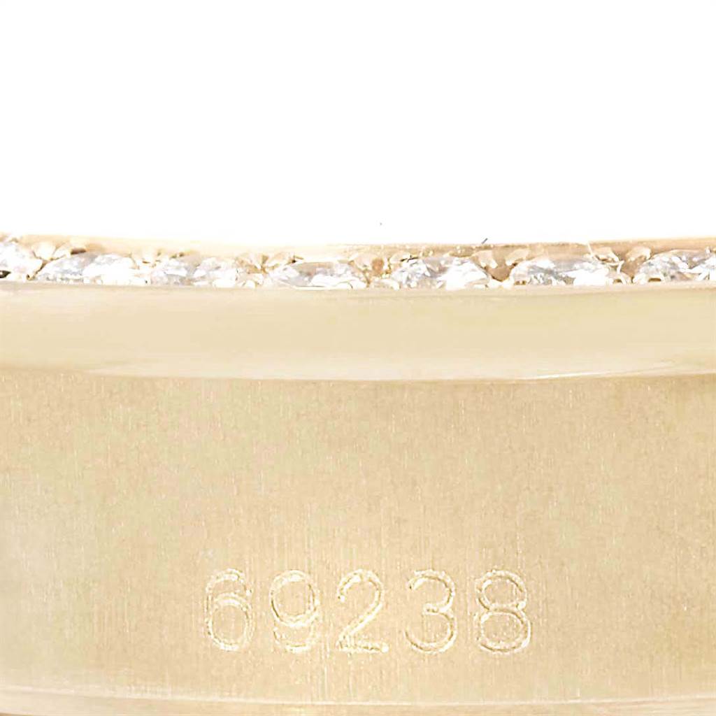 This close-up image features the side of a Rolex President 69238 Women
s Yellow Gold Black Dial 69238 Women
s Yellow Gold Black Dial model watch with a focus on the engraved model number 69238.