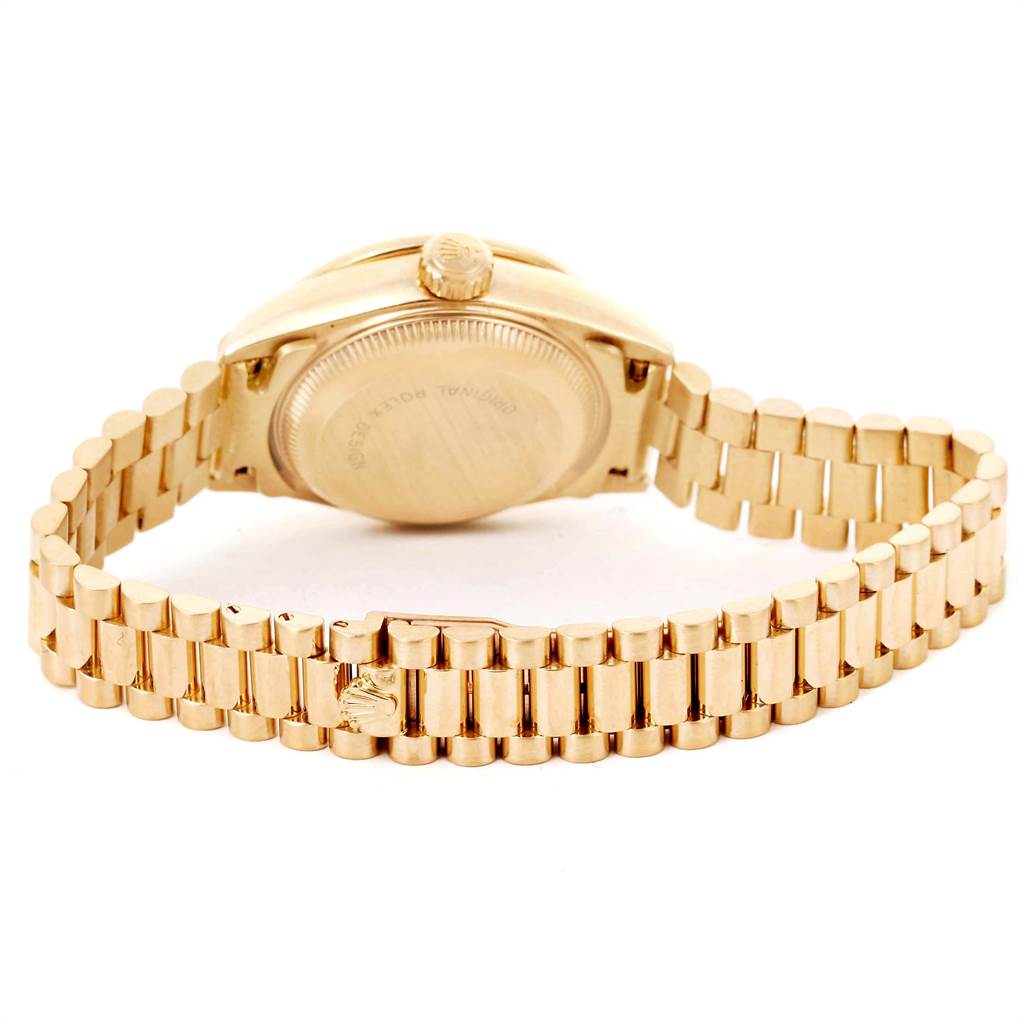 This image shows the back view of a Rolex President 69238 Women
s Yellow Gold Black Dial 69238 Women
s Yellow Gold Black Dial model watch, displaying the case back and the President bracelet.