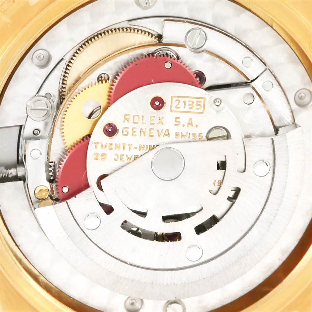 This image shows a close-up view of the movement mechanism of a Rolex President 68278 Women's Yellow Gold Champagne Dial 68278 Women's Yellow Gold Champagne Dial watch, featuring gears and internal components.
