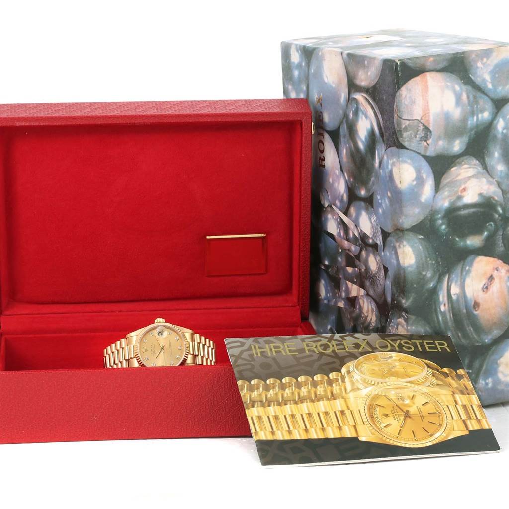 The image shows a Rolex President 68278 Women's Yellow Gold Champagne Dial 68278 Women's Yellow Gold Champagne Dial watch in a red box with an outer shell and a booklet beside it.