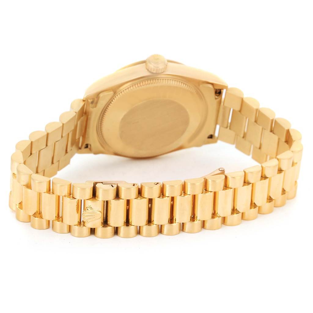 The Rolex President 68278 Women's Yellow Gold Champagne Dial 68278 Women's Yellow Gold Champagne Dial model watch is shown from the back, displaying its case, bracelet, and clasp.