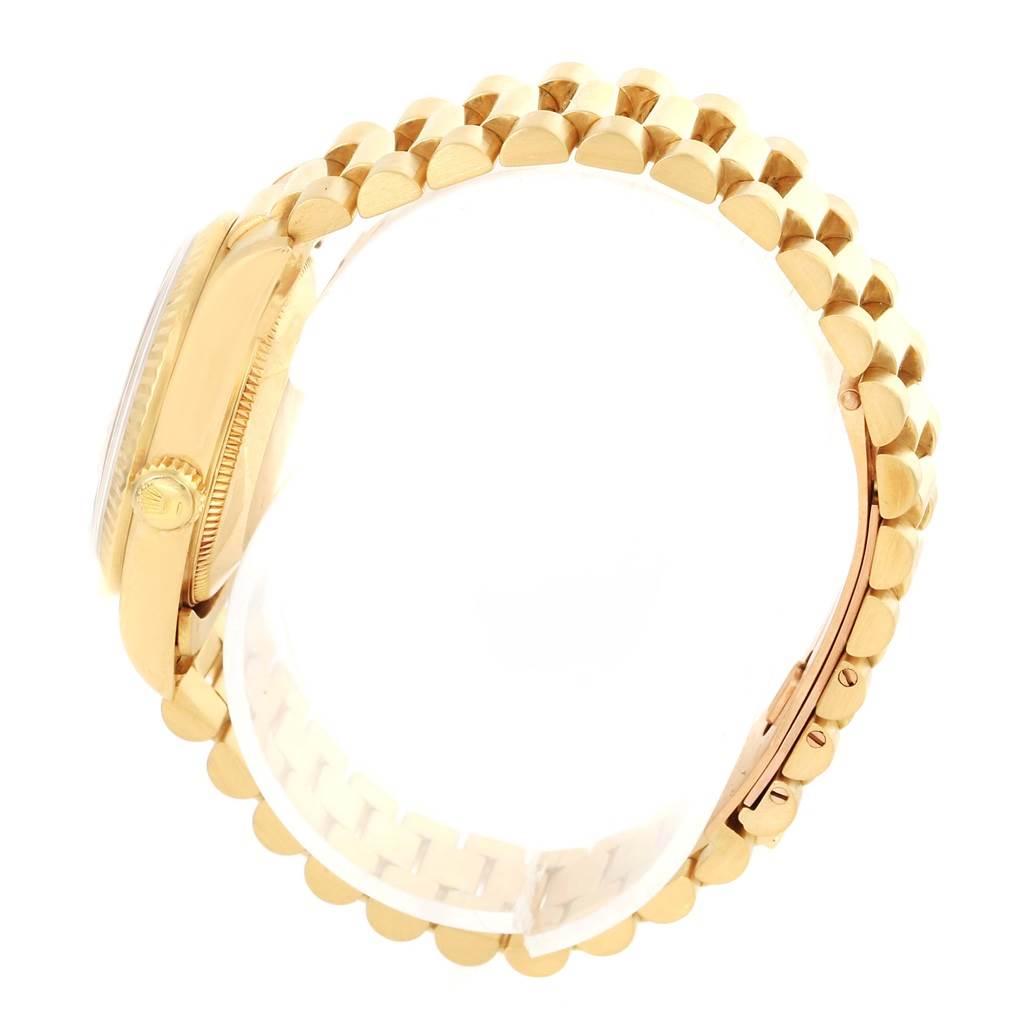 This side view image of the Rolex President 68278 Women's Yellow Gold Champagne Dial 68278 Women's Yellow Gold Champagne Dial model displays its gold case, crown, and a portion of its gold link bracelet.