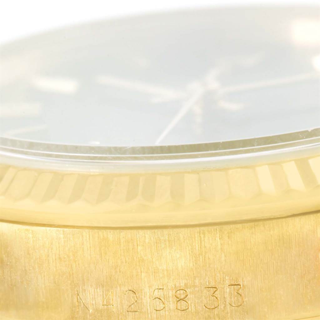 The image shows a close-up of the bezel, crystal, and a portion of the case with a serial number on the President model Rolex watch.