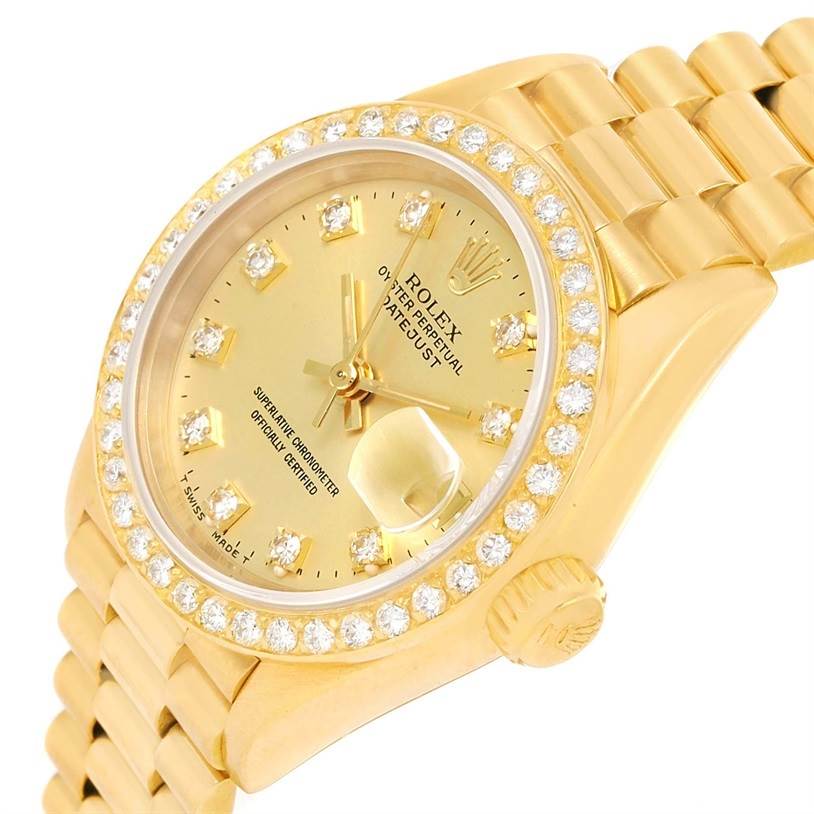 The image shows a Rolex President 69138 Women's Yellow Gold Champagne Dial 69138 Women's Yellow Gold Champagne Dial model watch at an angled top-down view, highlighting its gold dial, diamond bezel, and bracelet.