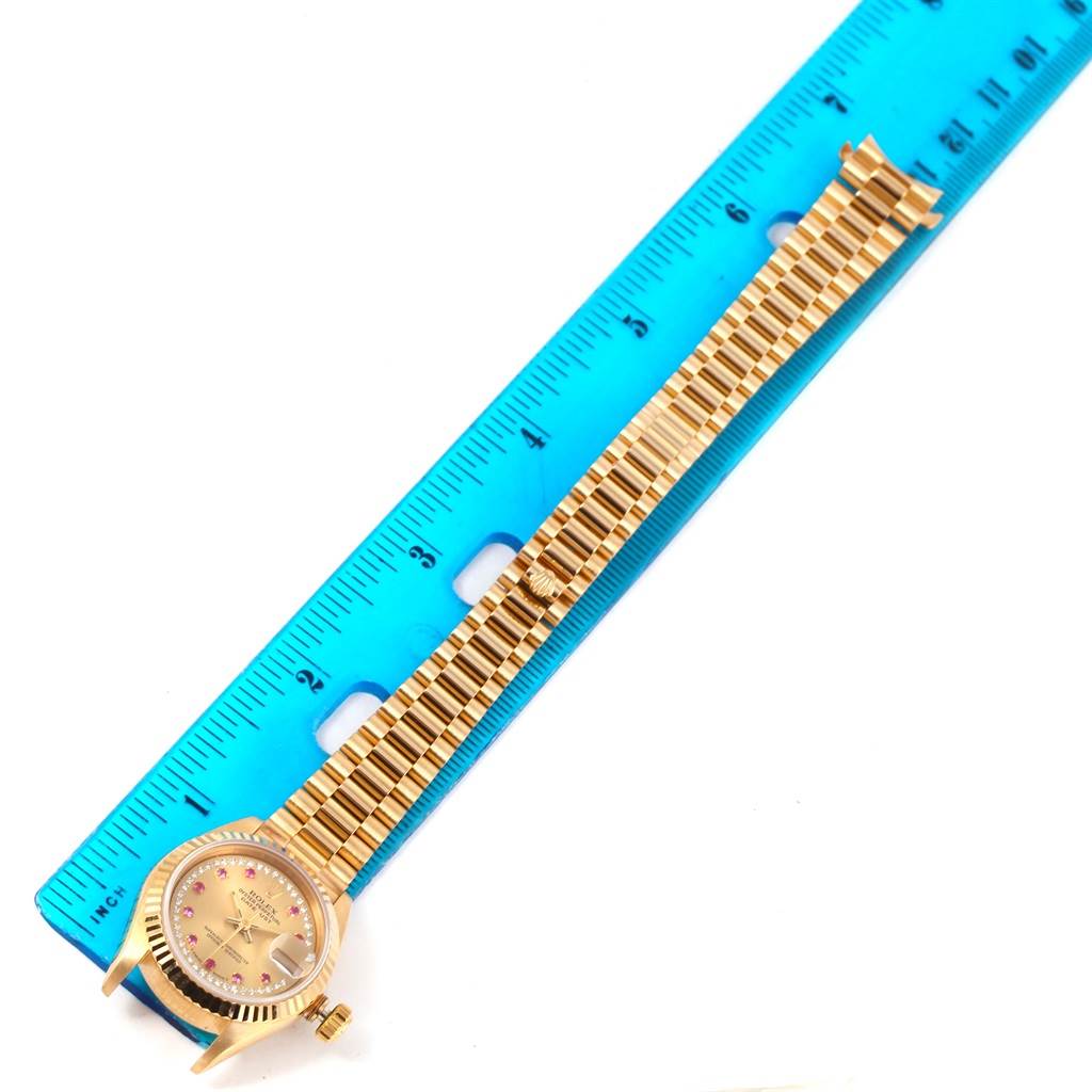 The image shows a President model Rolex watch, laid flat and measured with a blue ruler.