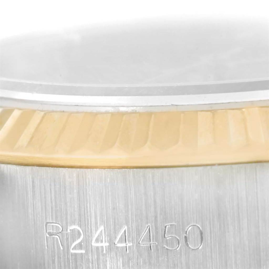 This close-up image shows the case side and fluted bezel of the Rolex President 69179 Women's White Gold Brown Dial 69179 Women's White Gold Brown Dial model, featuring a serial number engraving.