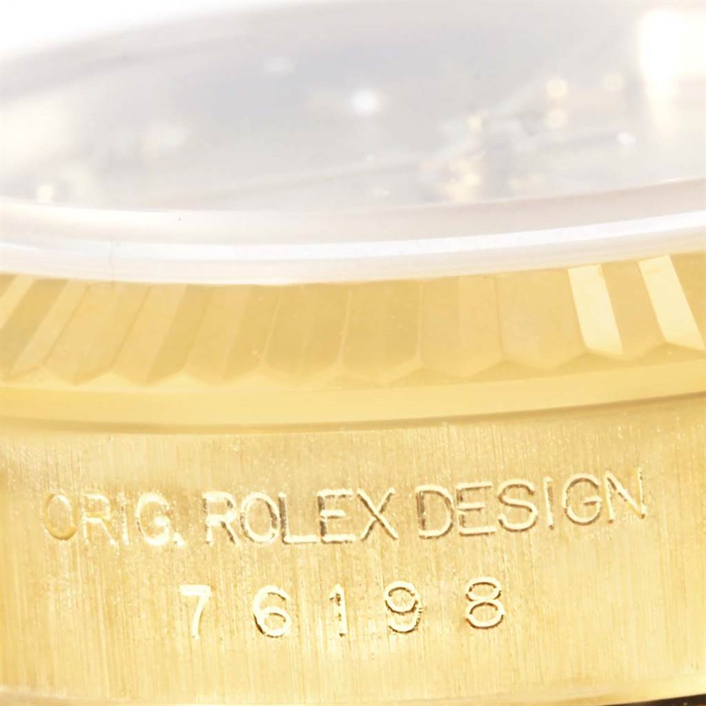 This is a close-up of a Rolex President 76198 Women's Yellow Gold Champagne Dial 76198 Women's Yellow Gold Champagne Dial watch showing the model number 76198 and "ORIG. ROLEX DESIGN" engraving on the case.