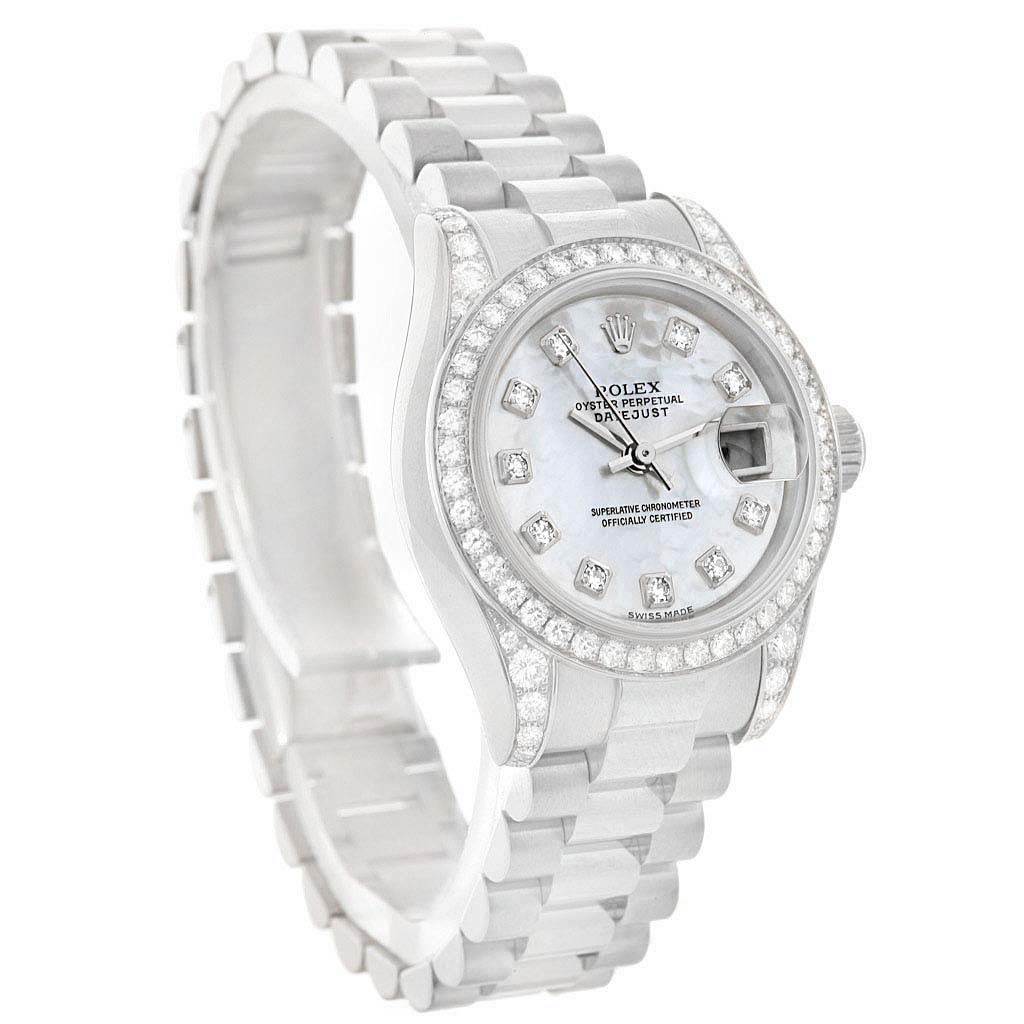 This Rolex President 179159 Women's White Gold Mother of Pearl Dial 179159 Women's White Gold Mother of Pearl Dial model watch is shown at a tilt angle, highlighting its face, band, and diamond-encrusted bezel.