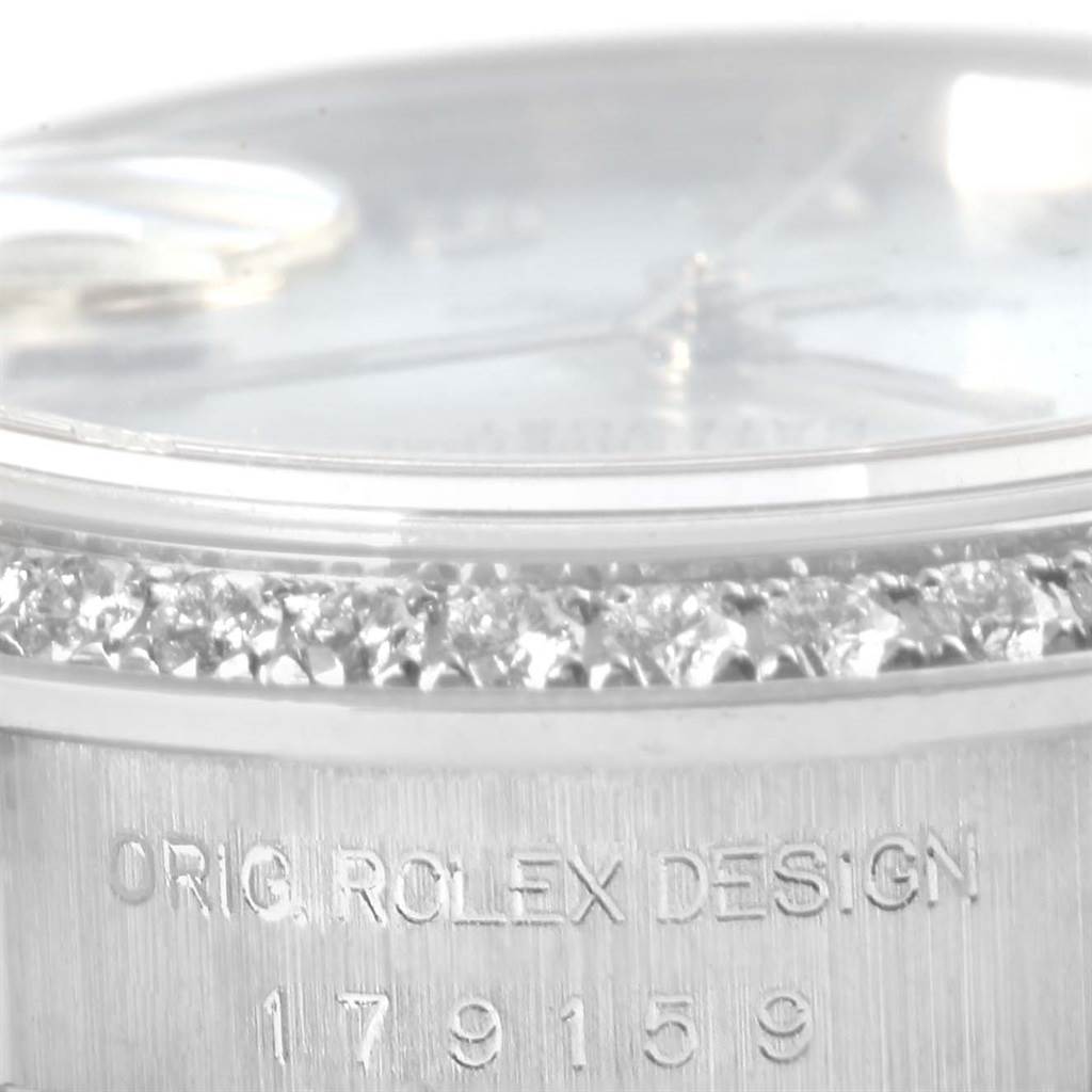 This close-up shows the diamond-studded bezel and part of the case of a Rolex President 179159 Women's White Gold Mother of Pearl Dial 179159 Women's White Gold Mother of Pearl Dial model watch, including its design number.