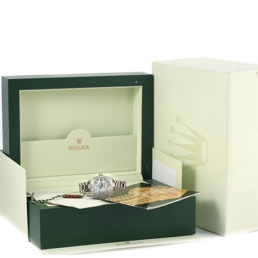 The image shows a Rolex President 179159 Women's White Gold Mother of Pearl Dial 179159 Women's White Gold Mother of Pearl Dial model watch with accessories, displayed inside a green and beige Rolex box.