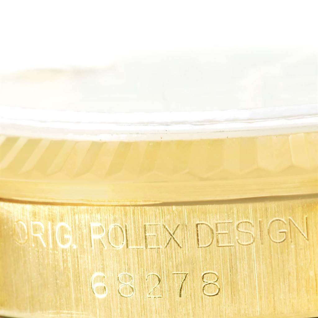 This close-up image shows the side of a Rolex President 68278 Women's Yellow Gold Champagne Dial 68278 Women's Yellow Gold Champagne Dial model watch, highlighting the "ORIG. ROLEX DESIGN 68278" engraving on the case.
