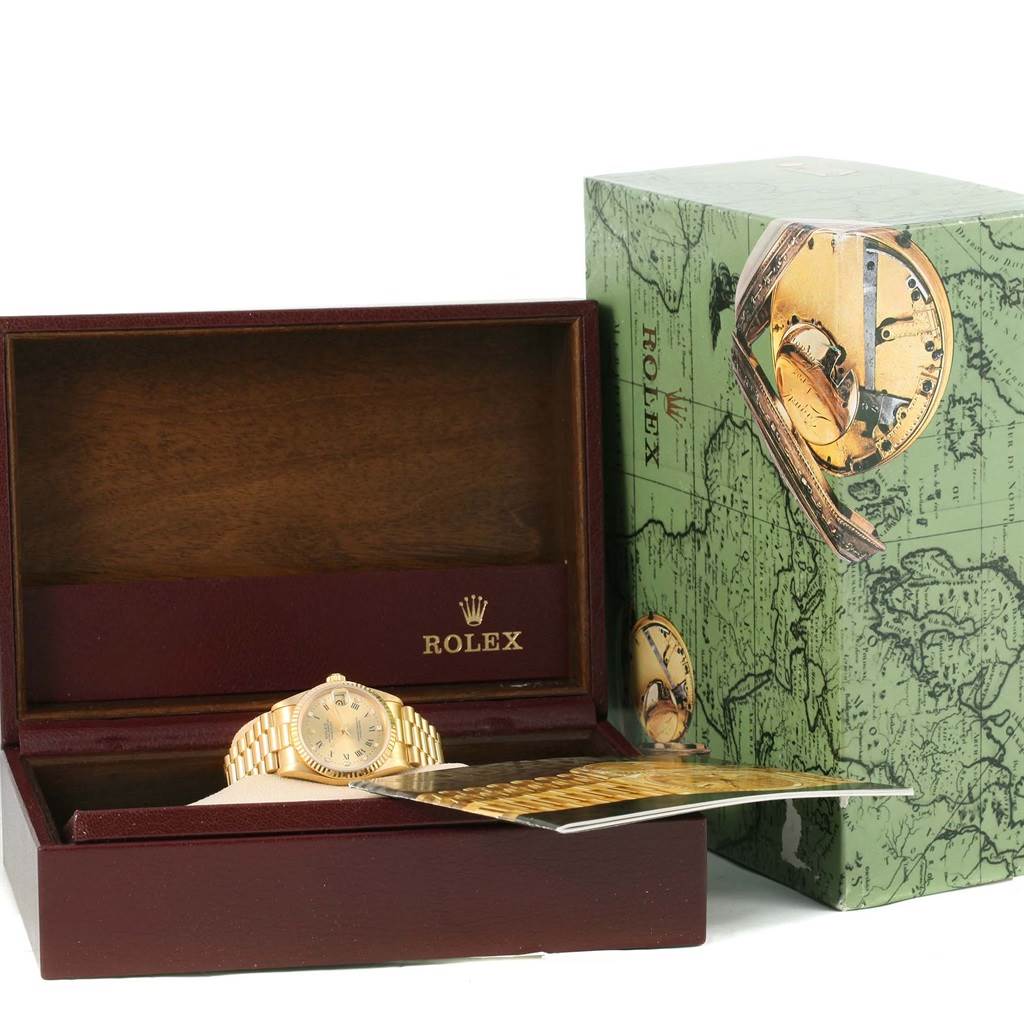 The Rolex President 68278 Women's Yellow Gold Champagne Dial 68278 Women's Yellow Gold Champagne Dial model watch is shown in its case at an angle, accompanied by the outer Rolex box and paperwork.