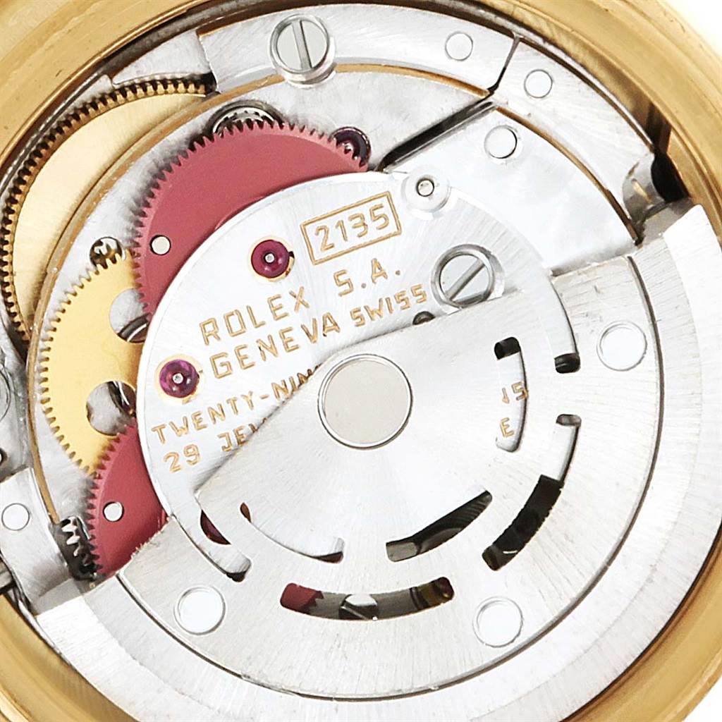 The image shows the movement mechanism of a Rolex President 69178 Women's Yellow Gold Blue Dial 69178 Women's Yellow Gold Blue Dial model watch, focusing on the internal gears and components.