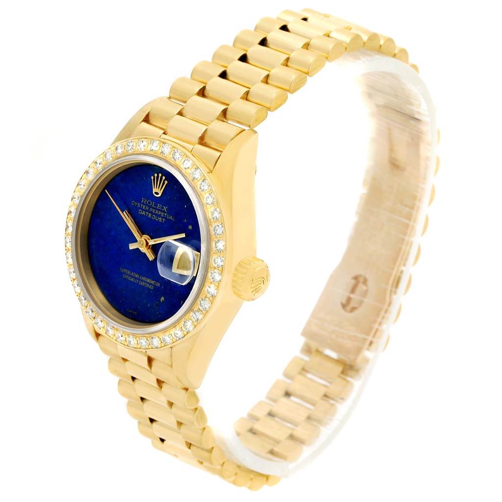 The Rolex President 69178 Women's Yellow Gold Blue Dial 69178 Women's Yellow Gold Blue Dial model watch is shown from an angled front view, highlighting the blue dial, diamond bezel, and gold bracelet.